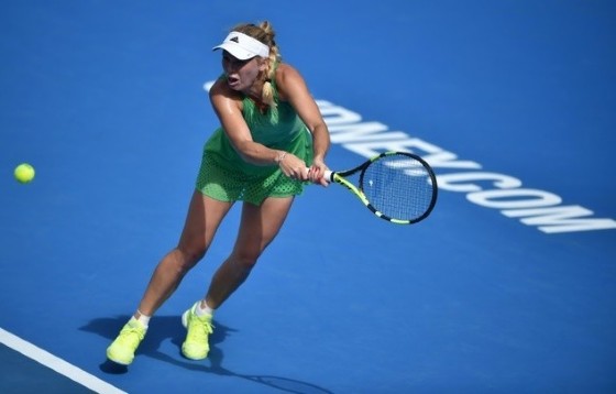 Caroline Wozniacki of Denmark hits a return to Monica Puig of Puerto Rico in their women's first round match at the Sydney International tennis tournament, on January 9, 2017