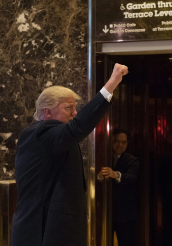 President-elect Donald Trump raises a fist to supporters in the lobby of Trump Tower in New York