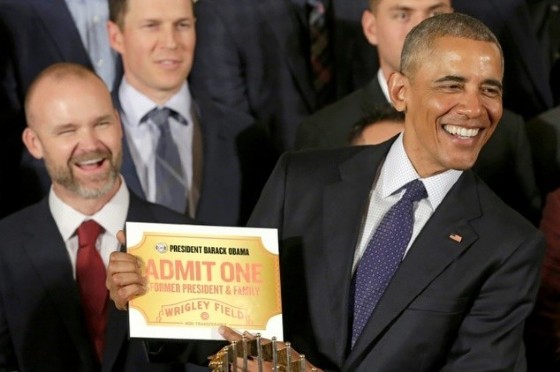 US President Barack Obama holds a lifetime admission certificate as he welcomes the Chicago Cubs baseball team to the White House on January 16, 2017
