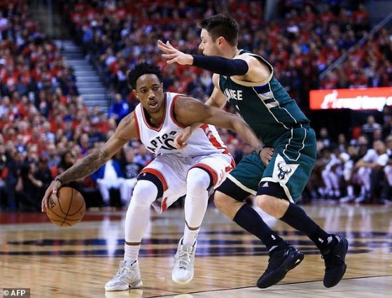 DeMar DeRozan of the Toronto Raptors dribbles the ball past Matthew Dellavedova of the Milwaukee Bucks in Game Two of the Eastern Conference quarter-finals, at Air Canada Centre in Toronto, Canada, on April 18, 2017