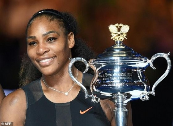 Serena Williams of the US holds the trophy following her victory over her sister Venus Williams of the US in the women's singles final on day 13 of the Australian Open tennis tournament in Melbourne January 28, 2017