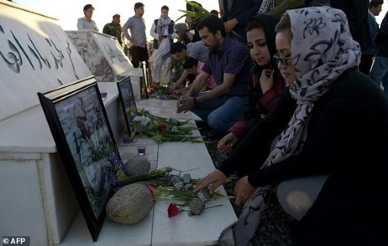 Afghan activists pay tribute to the victims of a Taliban attack on an army base -- the assault may have left 130 dead
