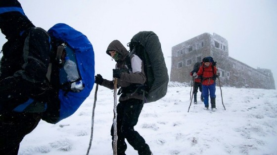 Tourists walk past Bilyi Slon, or the White Elephant, the highest inhabited building in Ukraine and an old astronomical observatory on Chornogora mountain on March 9, 2017