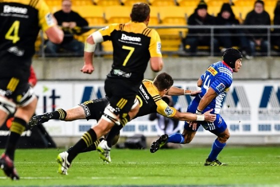 Wellington Hurricanes' Beauden Barrett tackles Stormers' Jan de Klerk (R) during their Super Rugby match, at Westpac Stadium in Wellington, on May 5, 2017