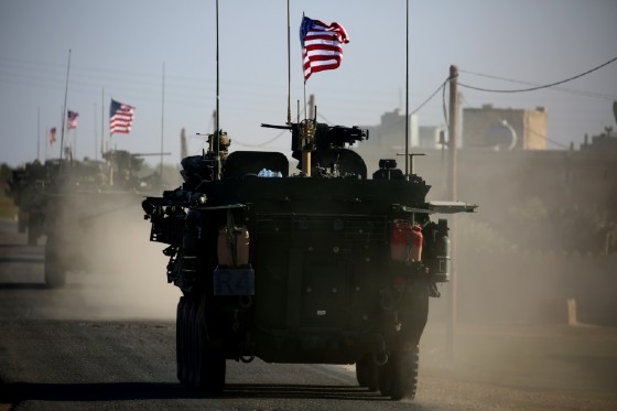 A convoy of US armoured vehicles drives past near the Syrian city of Manbij, which is held by the US-backed Syrian Democratic Forces, on March 5, 2017