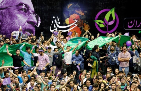 Thousands at an election rally for President Hassan Rouhani on May 13, 2017 chant the names of reformist leaders still locked away by the regime