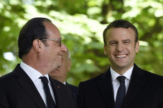 French President Francois Hollande (L) and newly elected president Emmanuel Macron attend a ceremony to mark the anniversary of the abolition of slavery, at the Jardins du Luxembourg in Paris, on May 10, 2017
