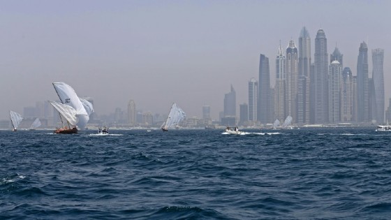 Dhows participate in the Al-Gaffal traditional long-distance dhow sailing race near the finish line off of Dubai on May 14, 2017