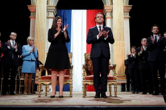 French President Emmanuel Macron and Paris' Mayor Anne Hidalgo applaud during an official ceremony at Paris' city hall after his formal inauguration as president on May 14, 2017