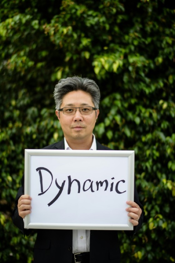 Financier Cedric Ko holds a board upon which he wrote a word to sum up his Hong Kong, ahead of the 20th anniversary of the city's transfer from Britain back to China.