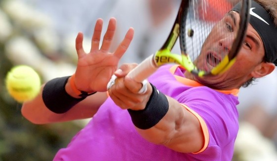 Rafael Nadal of Spain hits a return to Dominic Thiem of Austria during their quarter-final tennis match at the ATP Tennis Open tournament on May 19, 2017
