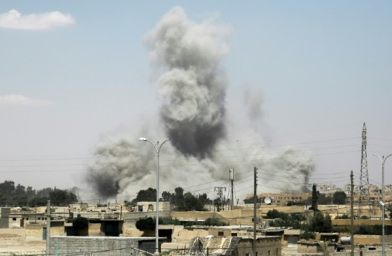 Smoke billows from buildings in the northern Syrian city of Raqa on June 18, 2017