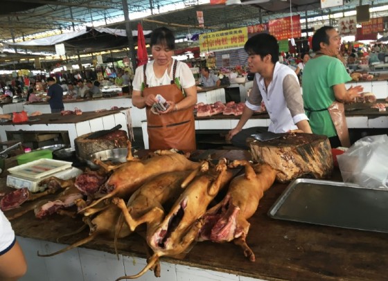 Vendors stand behind a pile of dog meat at the Nanqiao market in Yulin