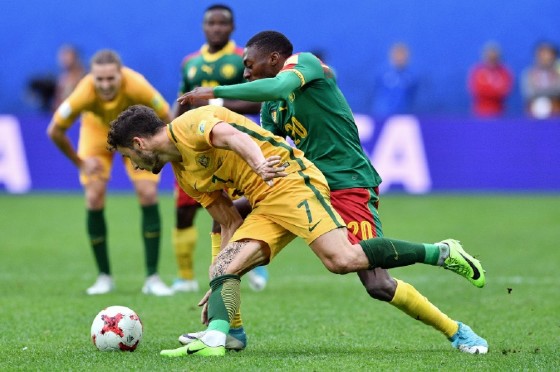 Australia's forward Mathew Leckie (front) is tackled by Cameroon's forward Karl Toko Ekambi during the 2017 Confederations Cup group B football match June 22, 2017