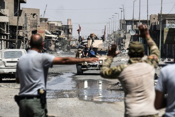 Iraqis fleeing the Old City of Mosul arrive in the industrial district of the city on June 23, 2017