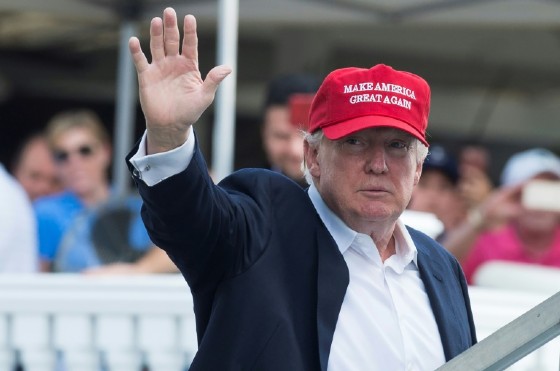 US President Donald Trump waves to well wishers as he arrives at the 72nd US Women's Open Golf Championship at Trump National Golf Course in Bedminster, New Jersey