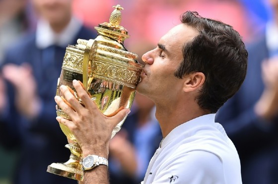 Switzerland's Roger Federer kisses the winner's trophy after beating Croatia's Marin Cilic in their men's singles final match at the 2017 Wimbledon Championships in southwest London, on July 16, 2017