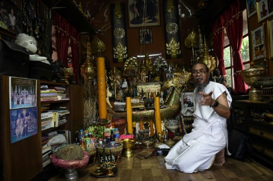 Surrounded by a cornucopia of glittering Buddha statues, eerie dolls and other spiritual trinkets, the 57-year-old Thai 'hermit' Toon uses powders and ointments to conduct his 'good luck' ritual.