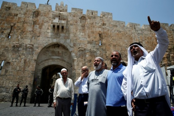 Palestinians chant slogans outside the Lions Gate, a main entrance to the Al-Aqsa mosque compound, due to newly implemented security measures by Israeli authorities, in Jerusalem's Old City on July 17, 2017