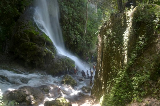 Haitian pilgrims bathe in the waterfall at Saut d'Eau to ward off evil