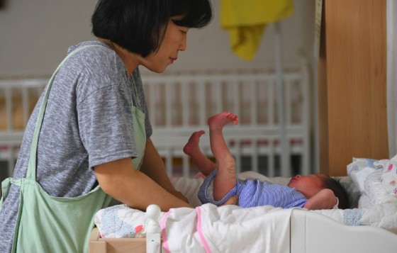 A social worker caring for a baby at the Jusarang Community Church in South Korea, where the number of abandoned babies has jumped in recent years in the wake of a law intended to protect children.