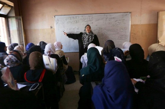 Iraqi girls attend a class at a school in west Mosul on July 27, 2017