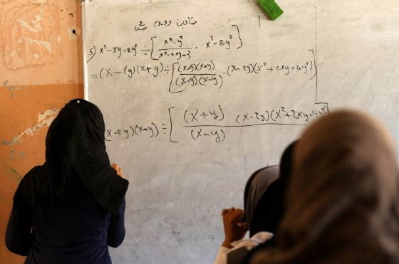 Iraqi girls attend a maths class at a school in western Mosul on July 27, 2017
