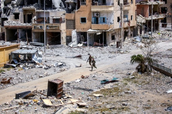 Members of the Syrian Democratic Forces (SDF) move through Raqa on July 28, 2017, as they fight the Islamic State group inside the city