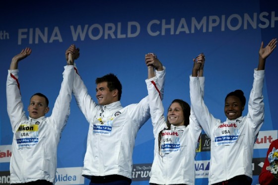 Americans Caeleb Remel Dressel, Nathan Adrian, Mallory Comerford and Simone Manuel celebrate after the mixed 4x100m freestyle final on July 29, 2017