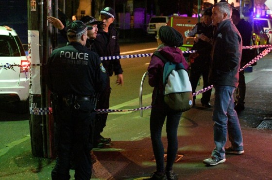Police speak to passersby as they man a check point in the inner Sydney suburb of Surry Hills on July 29, 2017. Four people were arrested in a series of raids across Sydney on July 29