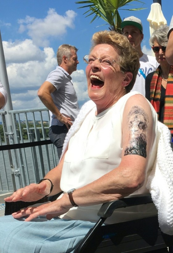 Maves Williams, grandmother of Great Britain's swimmer Adam Peaty, shows off her temporary tattoo, just like his grandson's, during the swimming competition at the 2017 FINA World Championships in Budapest