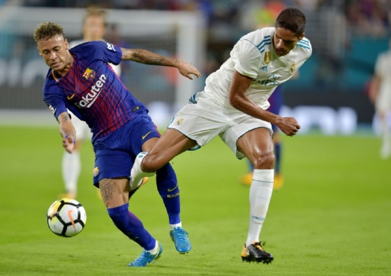 Neymar (L) of Barcelona challenges Raphael Varane of Real Madrid during their International Champions Cup football match in Miami, Florida