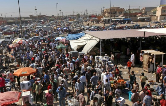 Iraqi merchants and shoppers jostle in the lively open-air market in Gogjali on the eastern outskirts of Mosul, on July 28, 2017
