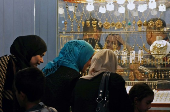 Iraqi women look at gold jewelry displayed at a market in east Mosul, on July 28, 2017