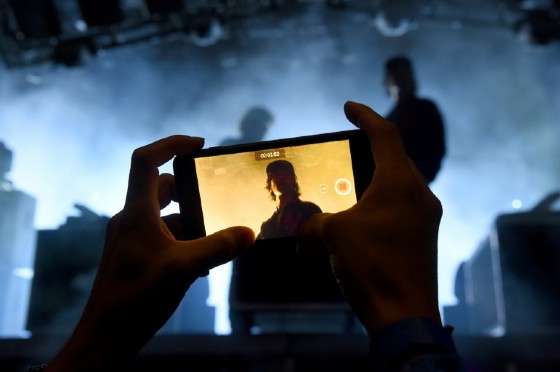 A fan takes cell phone video as the band Justice performs on the third and final day of the 2017 Panorama Music Festival