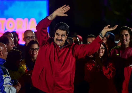 Venezuelan President Nicolas Maduro -- wearing the red associated with the socialist revolution started by his late mentor, Hugo Chavez -- celebrates Sunday's results