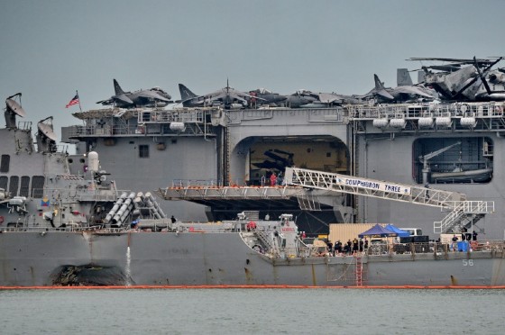 The guided-missile destroyer USS John S. McCain sailed into Singapore with a hole on its portside after a collision with a tanker