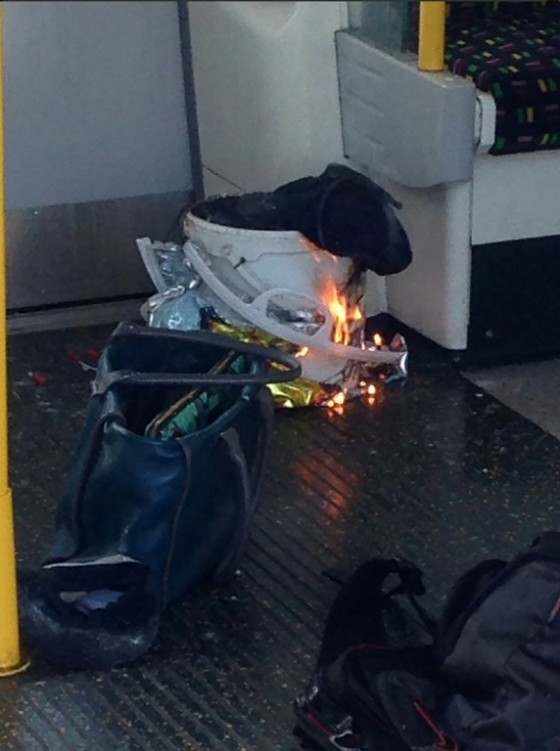 A handout picture obtained from twitter user @RRigs shows a white container burning inside a London Underground train carriage. British police are treating the incident as an act of terrorism.