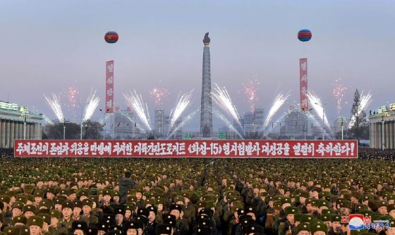 Photographs showed thousands of tightly packed soldiers and people applauding on Pyongyang's Kim Il-Sung square, which was decorated with large portraits of the North's late leaders.