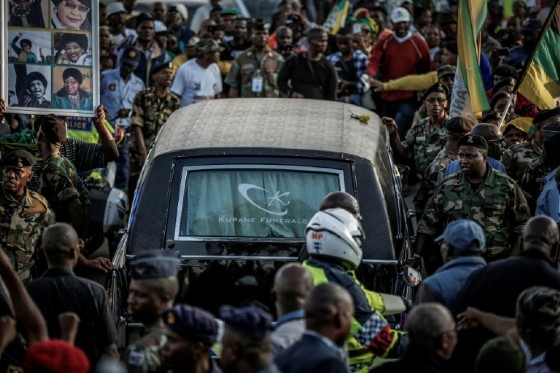Mourners line the streets of Soweto as a hearse carrying the body of Winnie Mandela makes its way through the township