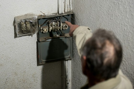 A resident points to syringes left by drug users outside one of Barcelona's drug flats